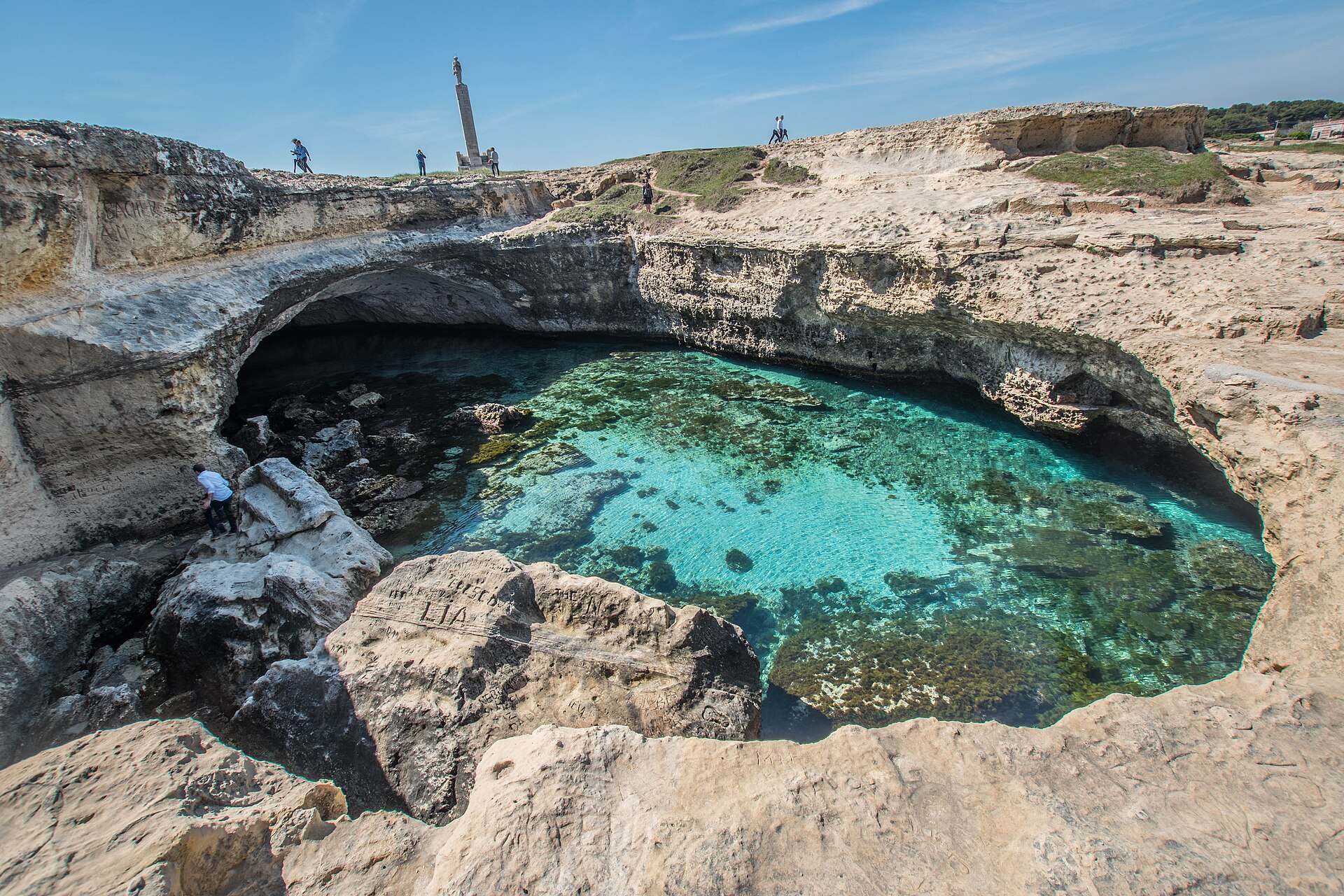 The clear turquoise pool of Grotta della Poesia in the limestone rock